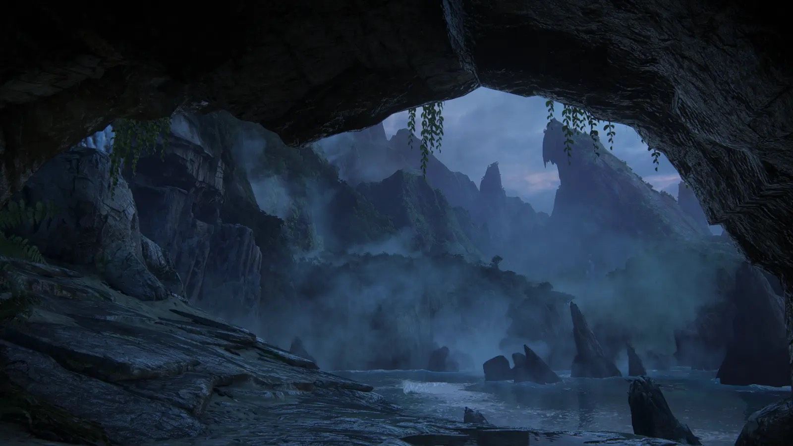 A foggy cliff face surrounded by a calm ocean following a storm.