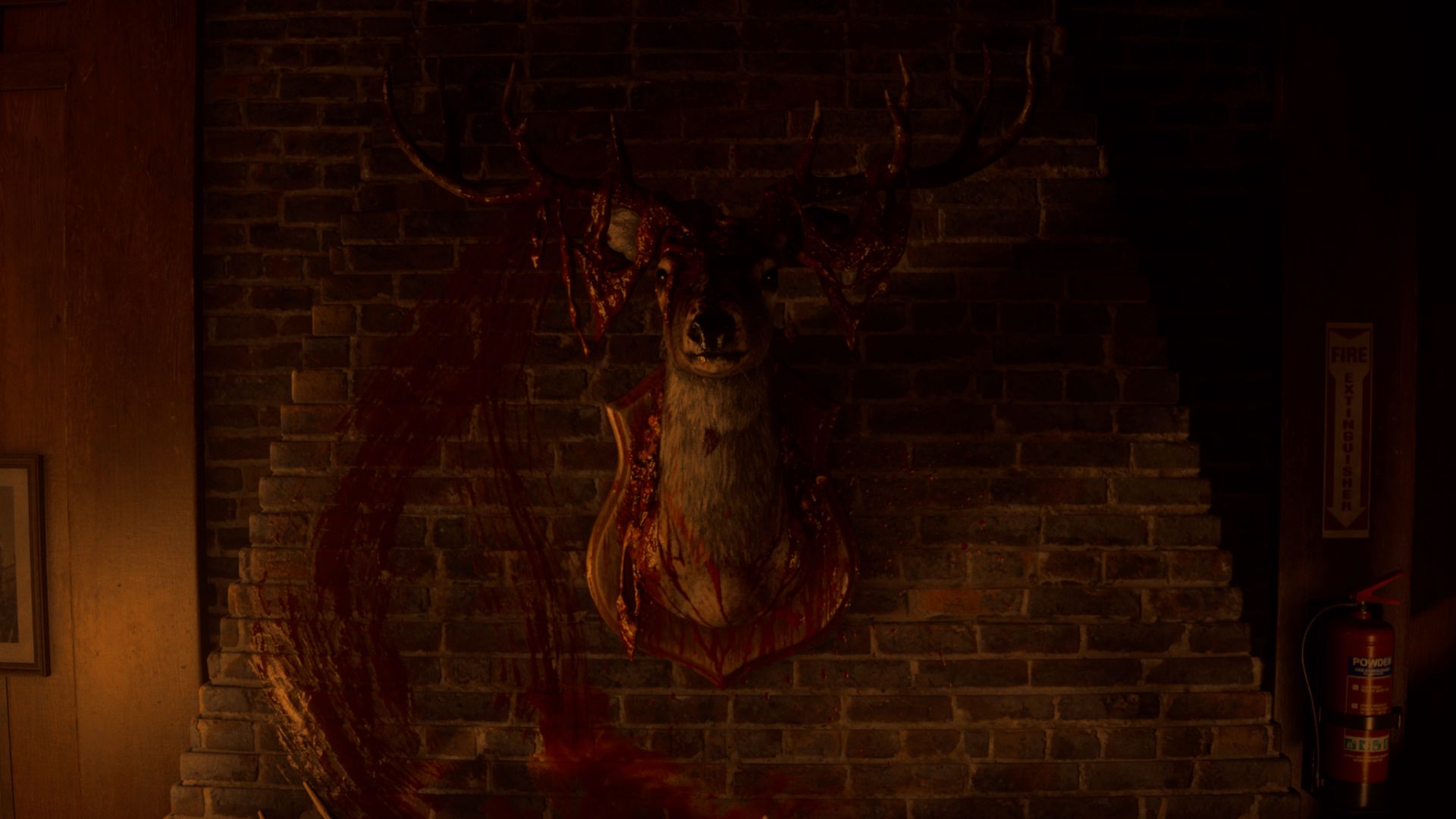A mounted deer head with blood-splattered antlers and plaque against a brick wall, with a large, dark red smear resembling a circle nearby.