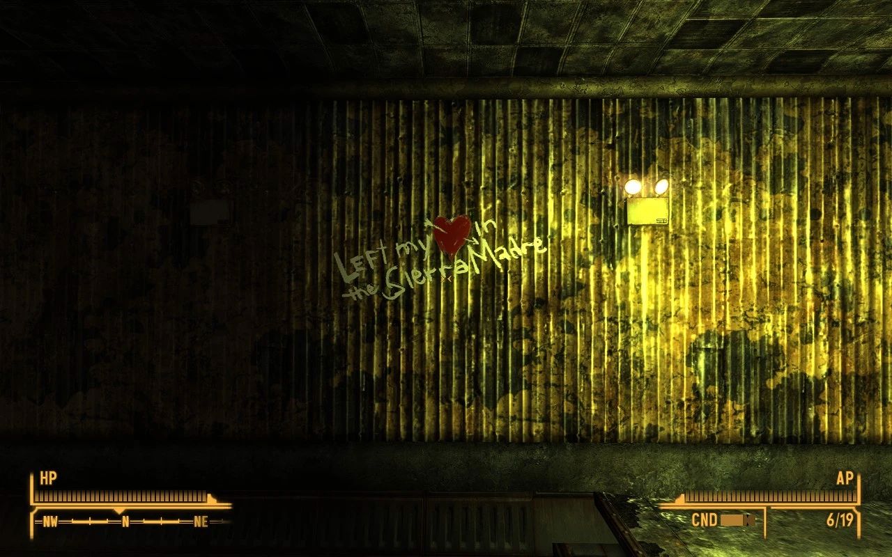 Graffiti on a grungy, yellow-stained metal wall reads “Left my heart in the Sierra Madre” with a red heart symbol replacing the word “heart.”