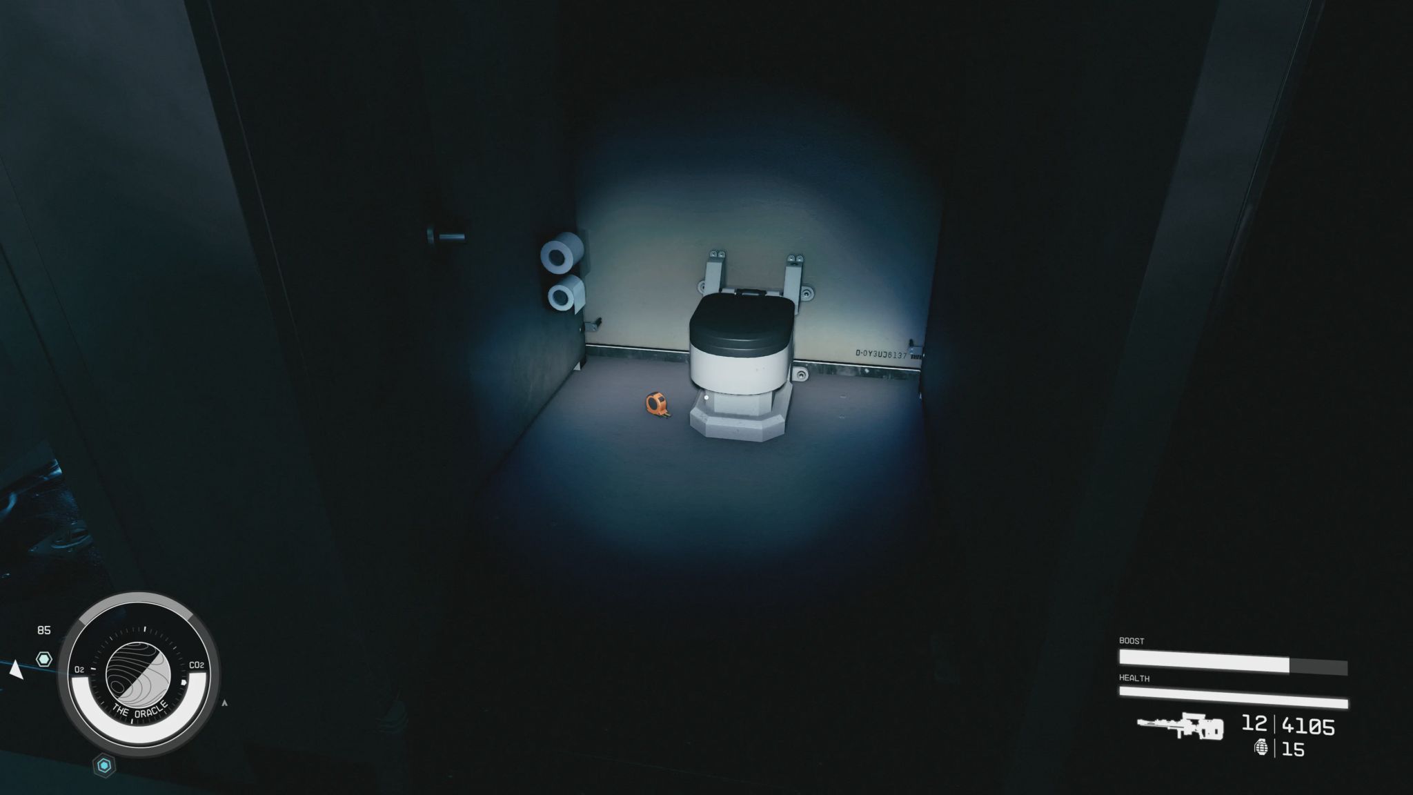 Screenshot from Starfield, showing a bathroom cubical, with a measuring tape on the floor next to the toilet